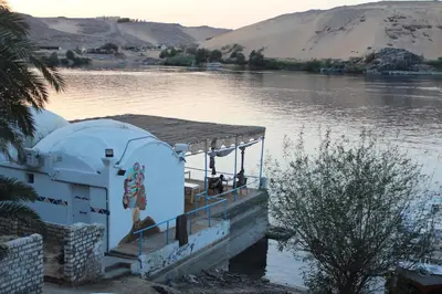 a building on the side of a body of water at Nile View Guest House in Aswan