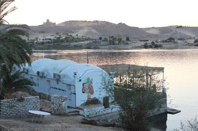 a building next to a body of water at Nile View Guest House in Aswan
