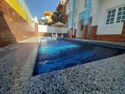 a swimming pool in the middle of a building at Sunshine House in Luxor