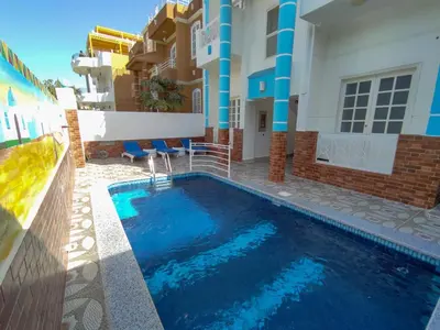 a swimming pool in front of a building at Sunshine House in Luxor