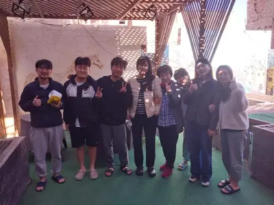 a group of people posing for a picture at Al Amir Palace Hotel in Suwhaj