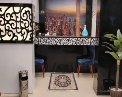 a living room with a painting of a city at Al Amir Palace Hotel in Suwhaj