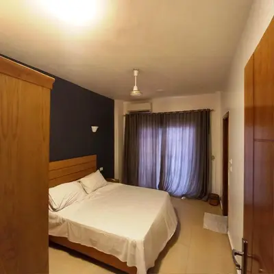a bedroom with a white bed and a window at Ali Luxury Villa in Luxor