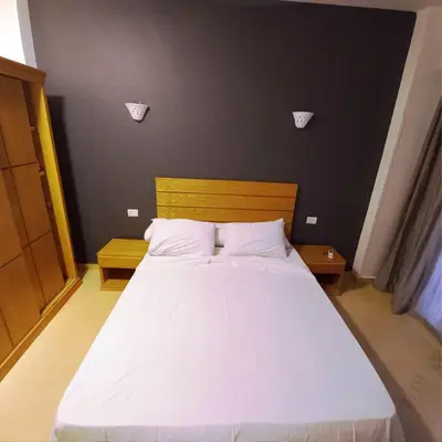 a bedroom with a large white bed with two pillows at Ali Luxury Villa in Luxor