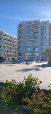 a large apartment building with a large parking lot at شقة علي البحر 2 in Hurghada