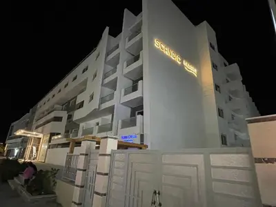 a white building with a sign on the side of it at شقة علي البحر 2 in Hurghada
