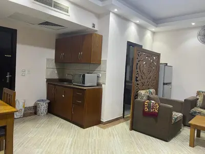 a living room with a couch and a microwave at Compound cecelia in Hurghada