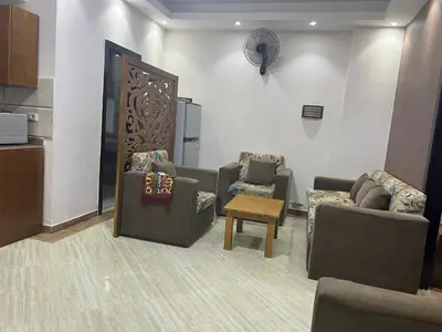a living room with two couches and a table at Compound cecelia in Hurghada