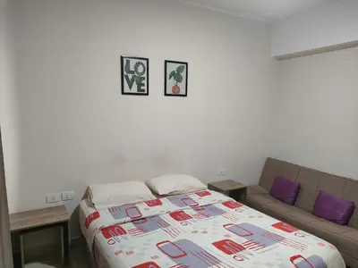 a bedroom with a bed and a couch at Aldau Heights lovely studio in Hurghada