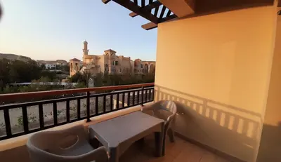 a balcony with a table and a view of a building at Aldau Heights Cozy big studio in Hurghada