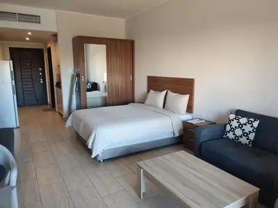a hotel room with a bed and a couch at Aldau Heights Cozy big studio in Hurghada