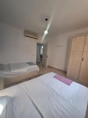 a bedroom with two beds and a closet at new marina . your best choice for family in Hurghada