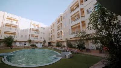 a swimming pool in a courtyard of a building at New Sunset Resort in Aswan