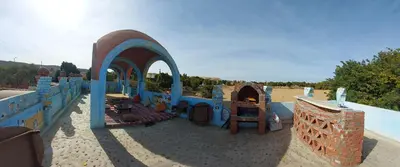 a childrens playground with a play set in the sand at Mostafa Nubian Guesthouse in Najâ€˜ al MadÄbb