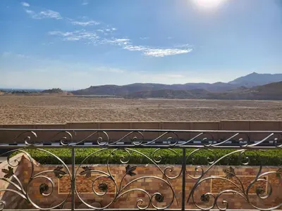 a view of the desert from a balcony with a bench at Royal Mountain in Luxor