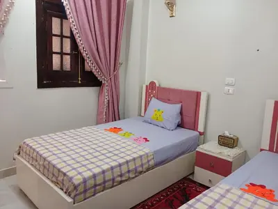 a small bedroom with a bed and a window at Cattleya Guesthouse in Aswan