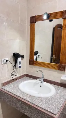 a bathroom counter with a sink and a mirror at Mikhaila Guest House in Luxor