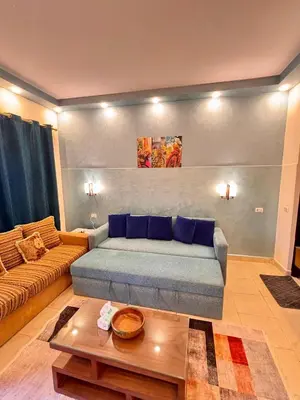 a living room with a couch and a table at Snorkeling Paradise 5 Star Resort Stella Makadi in Hurghada