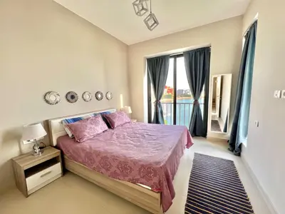 a bedroom with a bed and a large window at Luxury 3BR Townhouse, Tawila, El Gouna, Lagoon & Pool access in Hurghada