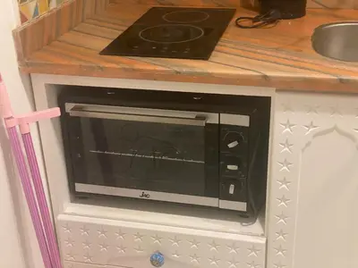 a microwave oven sitting on top of a kitchen counter at One Bedroom with Balcony WI-FI Downtown Sheraton Plaza 226 in Hurghada