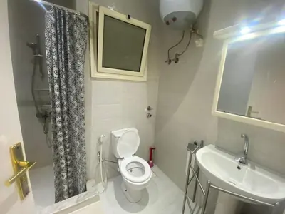 a small bathroom with a toilet and a sink at One Bedroom with Balcony WI-FI Downtown Sheraton Plaza 226 in Hurghada