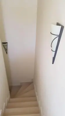 a stairway leading up to a white room with stairs at Sahl Hasheesh Deluxe penthouse Veranda in Sahl Hasheesh