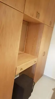 a wooden cupboard with a desk in a room at Sahl Hasheesh Deluxe penthouse Veranda in Sahl Hasheesh
