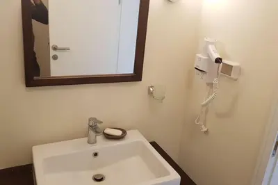 a bathroom with a sink and a phone on the wall at Sahl Hasheesh Deluxe penthouse Veranda in Sahl Hasheesh