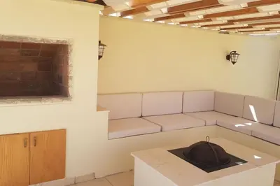 a living room with a couch and a table at Sahl Hasheesh Deluxe penthouse Veranda in Sahl Hasheesh
