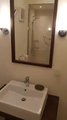 a bathroom with a white sink and a mirror at Sahl Hasheesh Deluxe penthouse Veranda in Sahl Hasheesh