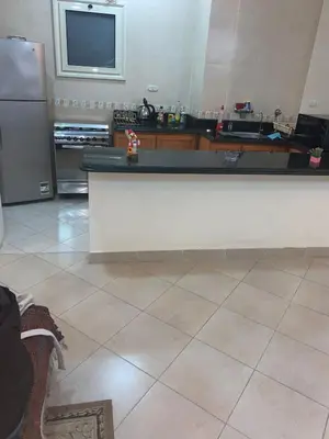 a kitchen with a white counter and a refrigerator at شقة سكنية ذات طابع عائلى متميز بها كافة الامكانيات من فلتر ماء وواى فاى in Hurghada