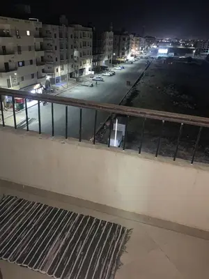 a view of a parking lot at night at شقة سكنية ذات طابع عائلى متميز بها كافة الامكانيات من فلتر ماء وواى فاى in Hurghada