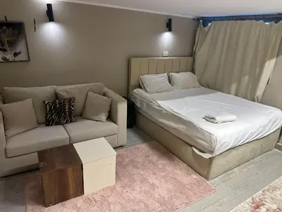 a small bedroom with a bed and a couch at Cheapest studio at El-Gouna - Bali compound in Hurghada