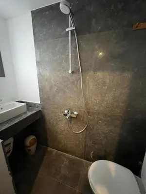 a bathroom with a shower with a toilet and a sink at Cheapest studio at El-Gouna - Bali compound in Hurghada