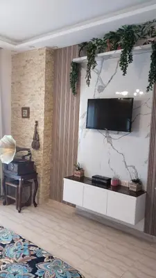 a living room with a tv on a wall at touristic centre in Hurghada