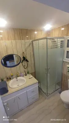 a bathroom with a shower and a sink and a toilet at touristic centre in Hurghada