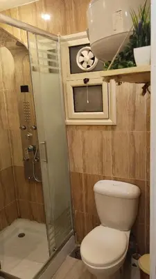 a small bathroom with a toilet and a shower at touristic centre in Hurghada