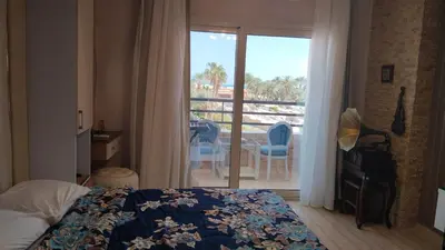 a bedroom with a bed and a view of a balcony at touristic centre in Hurghada