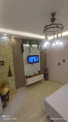 a living room with a flat screen tv on a wall at touristic centre in Hurghada