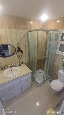 a bathroom with a shower and a sink and a toilet at touristic centre in Hurghada