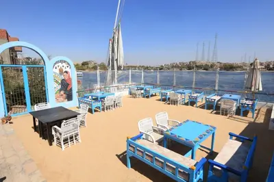 a deck of a cruise ship with tables and chairs at DoroKa Nubian House in Aswan