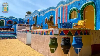 a colorful building with boots on the wall at Kato Waidi Nubian Resort in Aswan