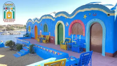 a small blue building with colorful chairs and tables at Kato Waidi Nubian Resort in Aswan