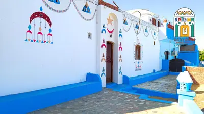 a building with blue and white walls and a staircase at Kato Waidi Nubian Resort in Aswan
