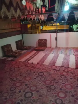 a room with two chairs and a rug at Zekry nubian guest house in Aswan