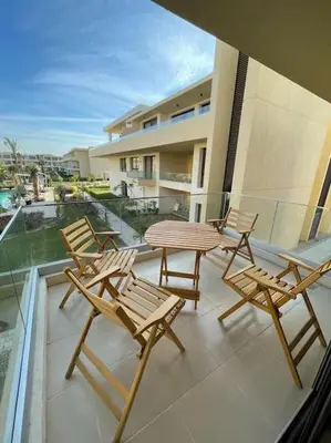 a patio with chairs and a table on a balcony at Cozy studio in G cribs in Hurghada