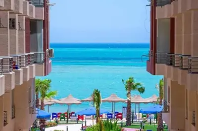 a view of the beach from between two buildings at كذا بلانكا بيتش 220 in Hurghada