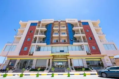 a large building with a car parked in front of it at كذا بلانكا بيتش 220 in Hurghada