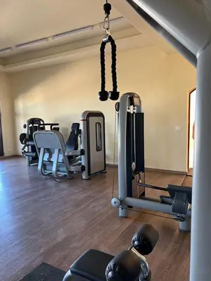 a gym with a bunch of equipment in a room at Makadi heights luxury complex in Hurghada