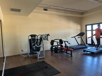 a gym with several tread machines in a room at Makadi heights luxury complex in Hurghada